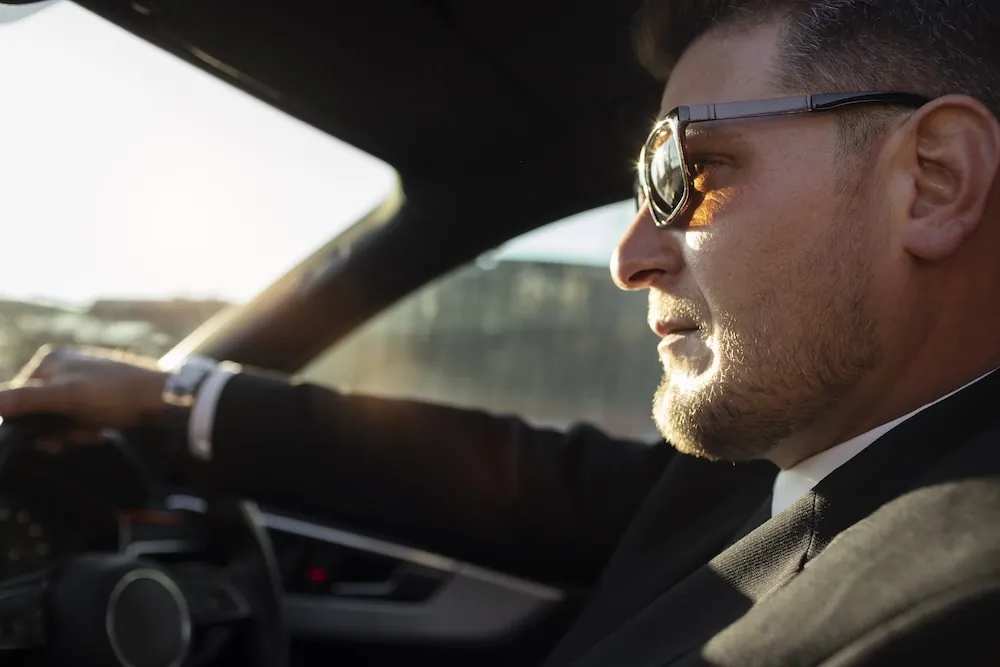 Professional chauffeur driving a luxury car through London — the most comfortable way to travel around the city